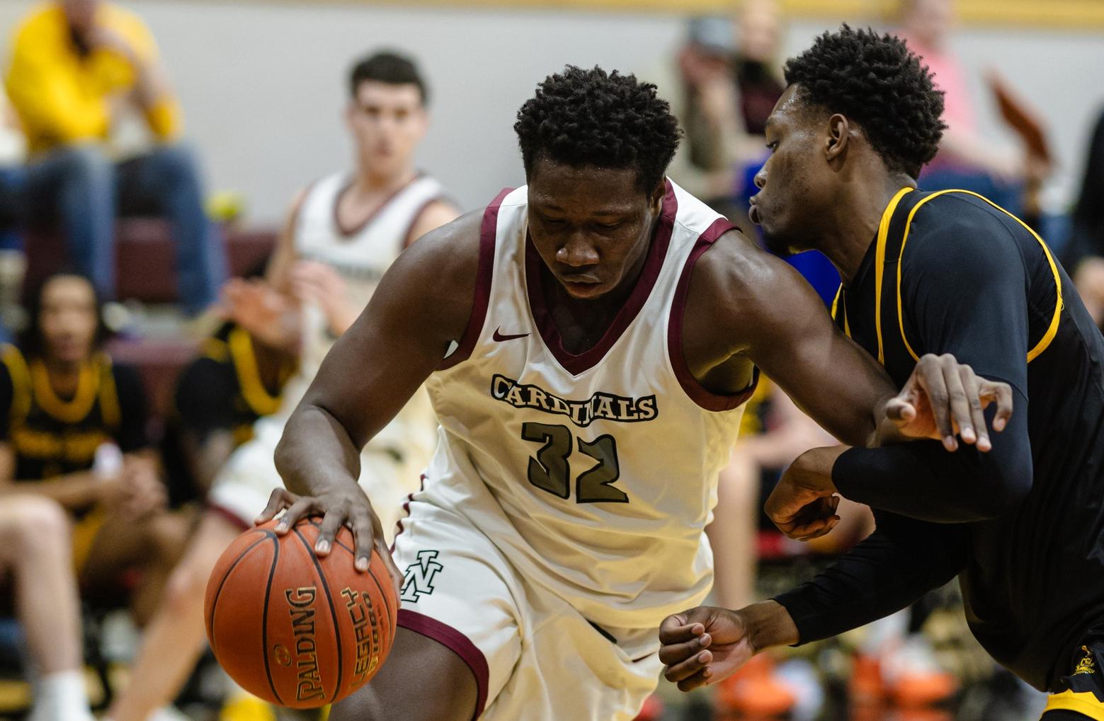 Aly Toure drives past CSI defender in Christianson Gymnasium. 