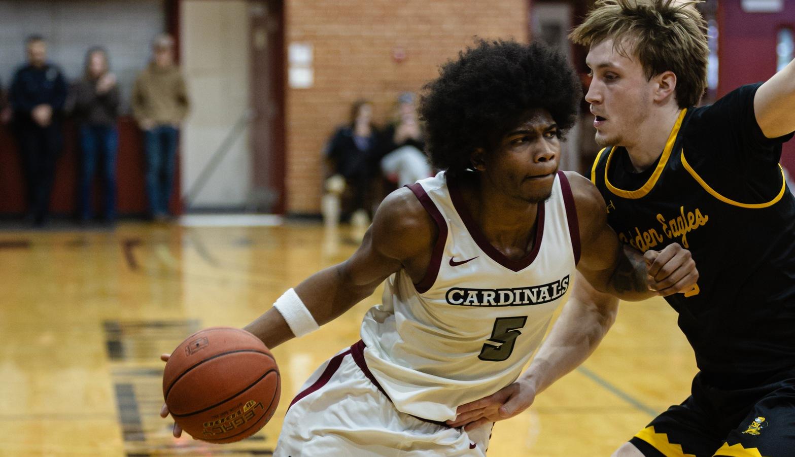 Ajayi Simmons dribbles the ball past a defender in Christianson Gymnasium.