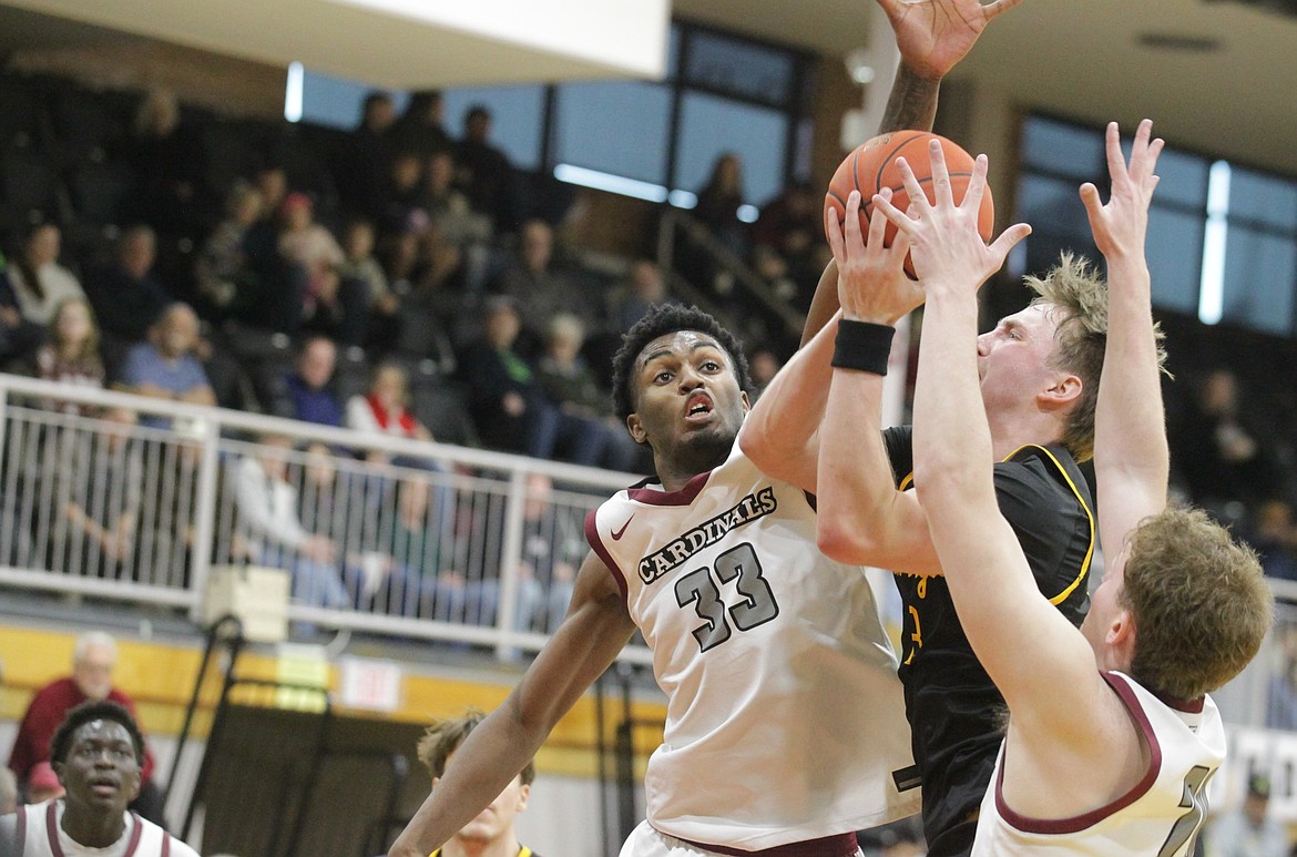 JASON ELLIOTT/Press North Idaho College sophomore forward Jacori Ervin (33) attempts to block the shot of College of Southern Idaho's Ben Thornbrue during the second half of Saturday's Scenic West Athletic opener at Rolly Williams Court.