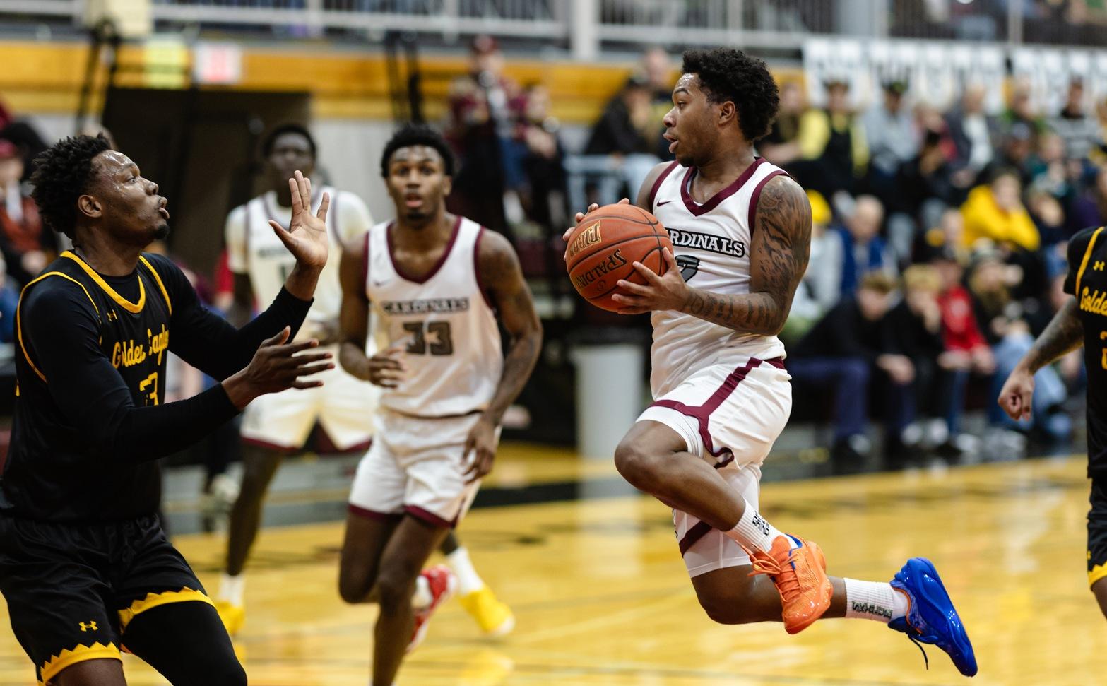 Nyale Robinson looks to pass the ball mid-air in Christianson Gymnasium.