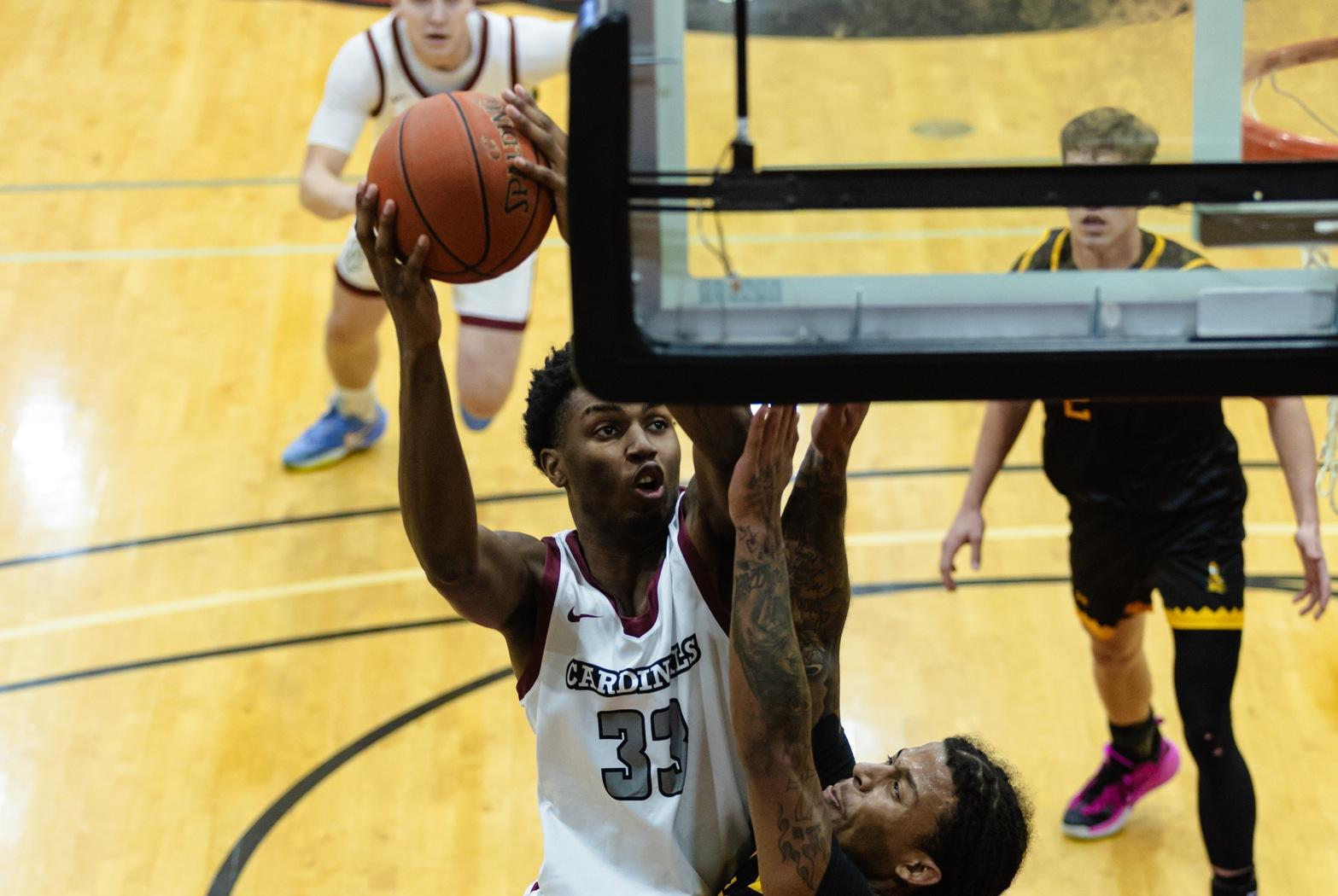 Jacori Ervin takes a shot over CSI defender in Christianson Gymnasium.