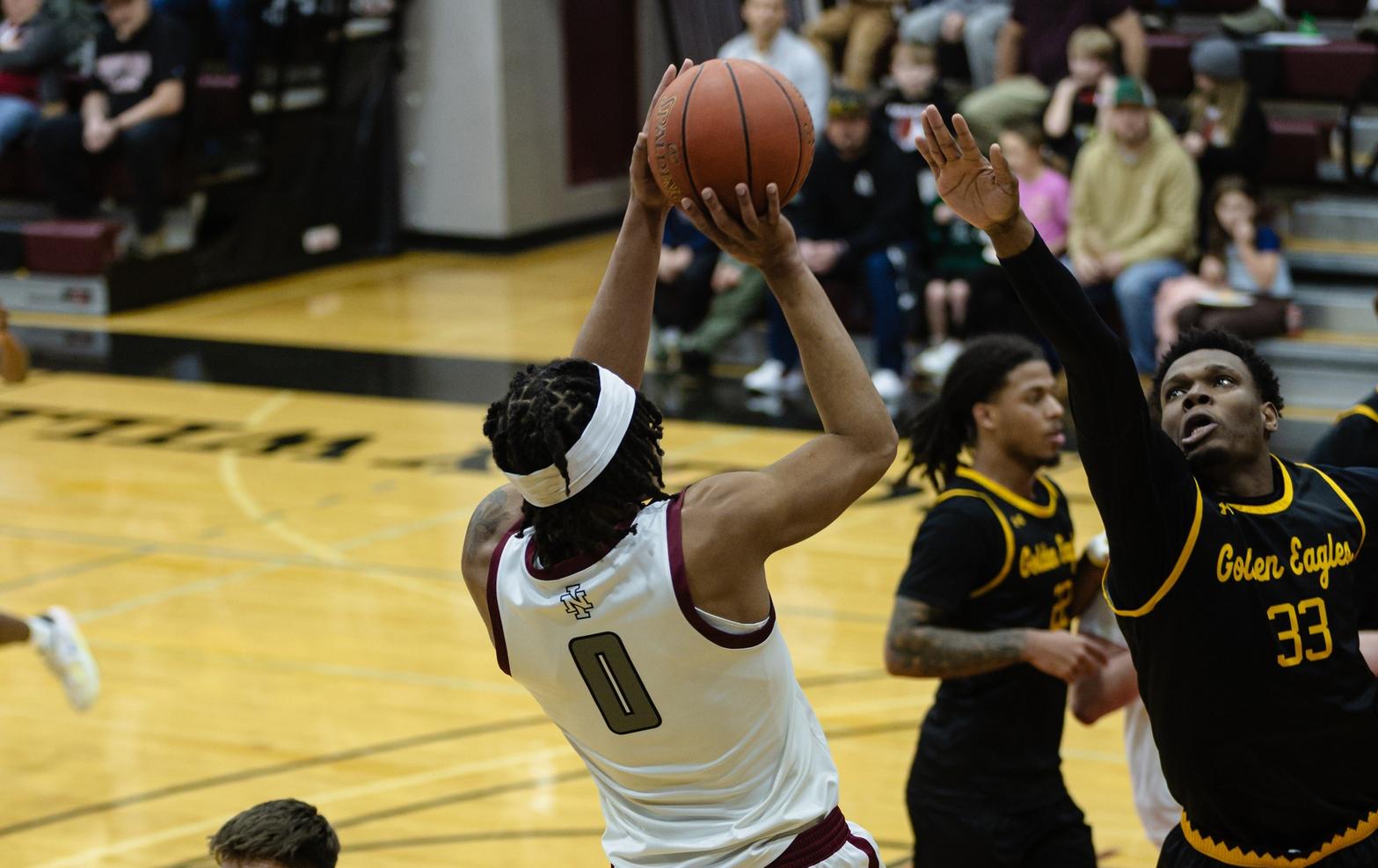 Nequan Brown shoots over defender in Christianson Gymnasium.