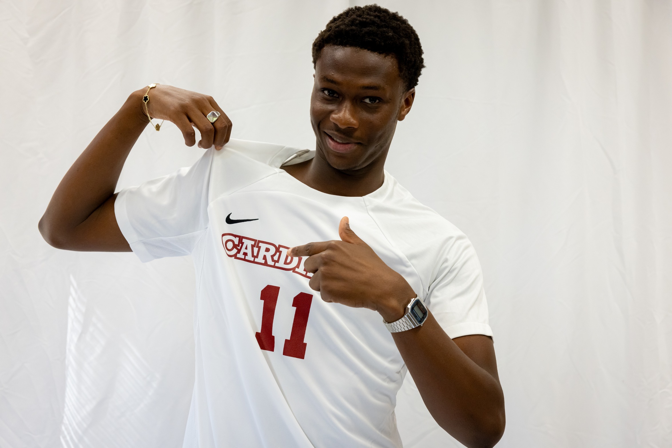 Mouhamed Fadel Fall points to his Cardinals jersey on media day.
