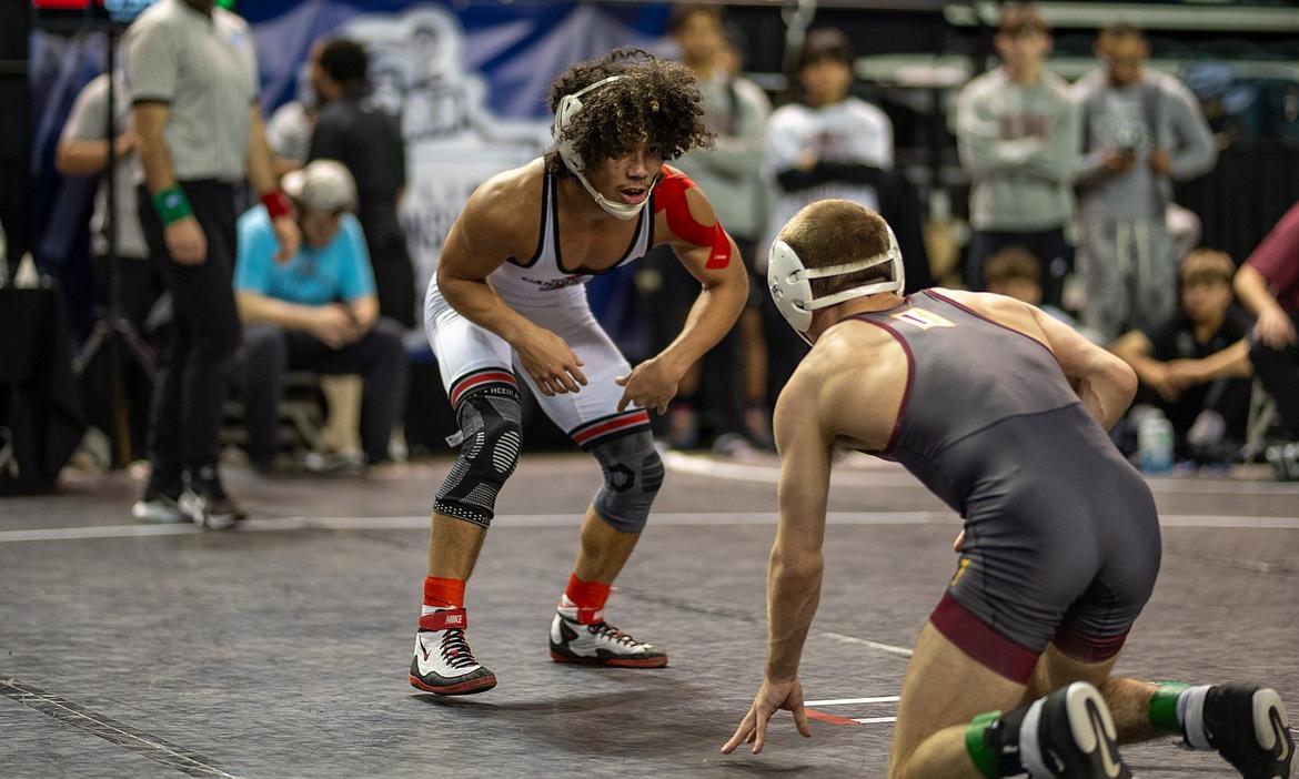 ELLI MICHAEL/North Idaho College athletics North Idaho College sophomore Elijah Cater battles with Indian Hills wrestler Riley Bettich during the consolation final at 125 pounds at the NJCAA Tournament at the Mid-American Center in Council Bluffs, Iowa.