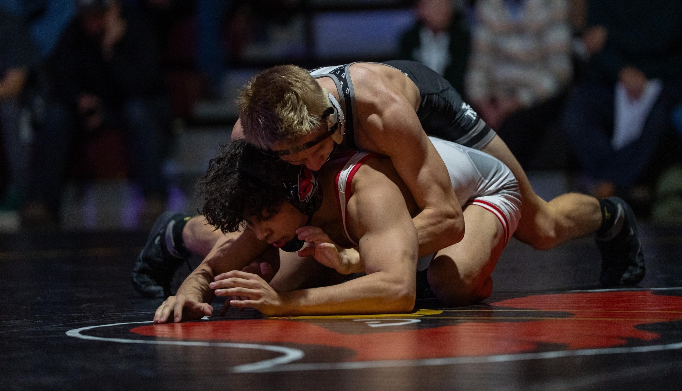 Hoyt Hvass on top of Clackamas opponent in Christianson Gymnasium. 